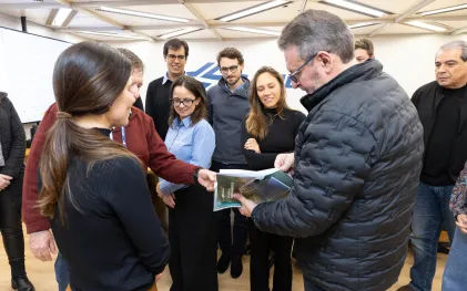 Na imagem, empregados da Sanepar e representantes do consórcio contratado para realizar os estudos e análises que resultaram no Plano de Descarbonização entregam uma versão impressa do documento ao diretor-presidente da Sanepar, Wilson Bley.