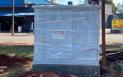 quadro de comando elétrico, parece uma armário de metal com duas portas, na cor cinza. fica num canteiro de uma rua