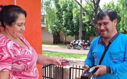 Agente efetua cobrança na porta da casa do cliente